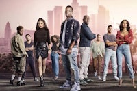 a group of people standing in front of a city